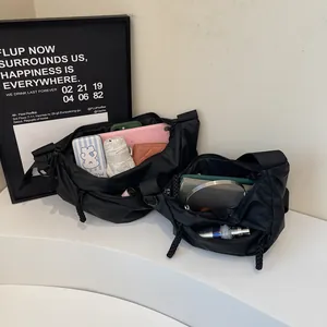 Minimalist black nylon half-moon crossbody bags in two sizes showing large storage capacity
