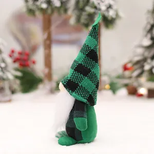 Forest gnome plush with green black plaid hat and white beard in winter snow background