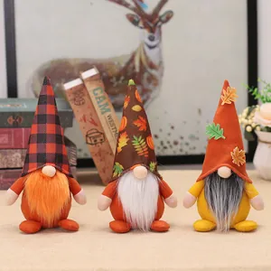 Three autumn harvest gnomes with maple leaf hats and long beards for Thanksgiving decor