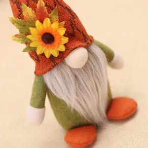 Harvest gnome with orange knit hat, sunflower decor and maple leaf for fall decor