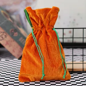 Orange velvet carrot gift bag with green drawstring closure for Halloween decorations