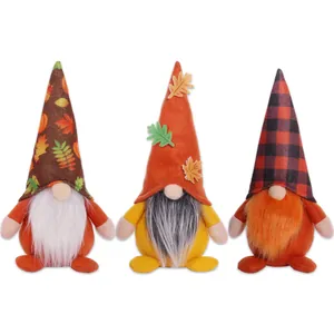 Three Thanksgiving fall gnomes with maple leaves and plaid hats on a clean white background