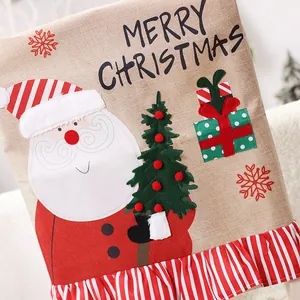 Christmas burlap chair cover featuring Santa Claus, Merry Christmas text and red ruffle