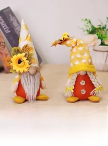 Detailed view of harvest festival gnome couple with sunflower hats and autumn accessories