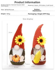 Detail of light-up harvest gnome plushies holding pumpkins and corn with sunflower hats