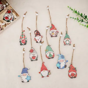 Set of colorful printed wooden Christmas gnomes with hanging strings and white beads