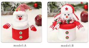 Detail of Christmas knitted candy jars with Santa and snowman motifs for holiday gifts