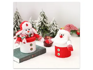 Detail of knitted Christmas snowman and Santa candy jars with festive holiday decor