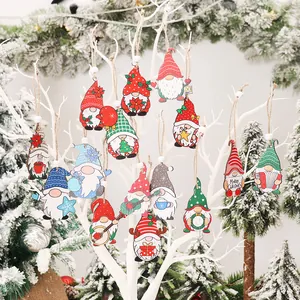 Christmas wooden gnome ornaments set hanging on white tree branches for festive decor