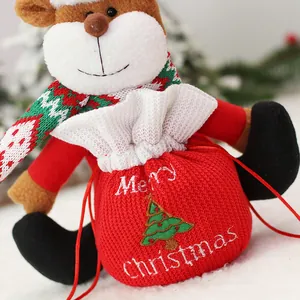 Christmas reindeer plush doll with a red knit drawstring gift bag for holiday candies