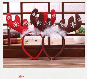 Detail of Christmas reindeer antler headbands with golden bells and snowflake patterns