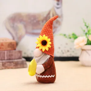 Lighted harvest gnome with knit orange hat and sunflower holding corn for fall decor