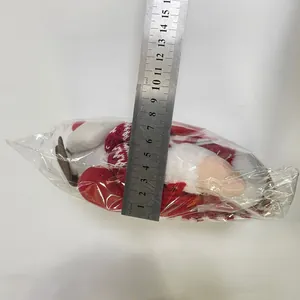 Dettaglio dello gnomo di Natale in peluche da 8cm misurato con un righello di metallo