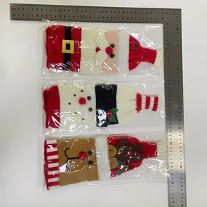 Close-up of knitted Christmas wine bottle covers with Santa, Snowman and Reindeer details