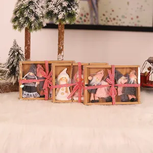 Nordic Christmas angel doll ornaments in gift boxes with festive ribbons and snow scene