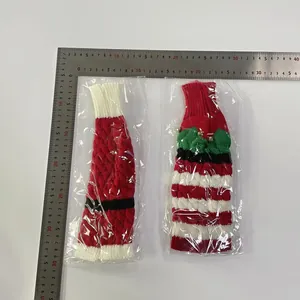 Close-up of knitted Christmas bottle covers with belt details and bells, size 30x12cm