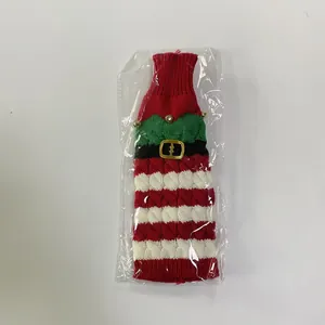 Close-up of a Christmas elf wine bottle cover with knit patterns and gold buckle details