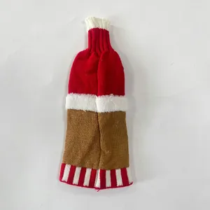 Detail of knitted Christmas wine bottle cover with red coffee colors and faux fur trim