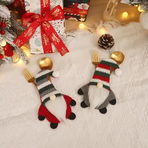 Christmas gnome cutlery holders with striped knit hats for festive dining table decor