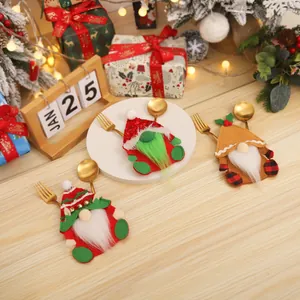 Three-piece Christmas gnome cutlery holders with sequins on a festive wooden table