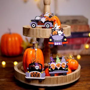 Wooden Halloween gnome and pumpkin pendants on rustic tray with festive decorations