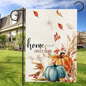 Garden flag with pumpkins and Home Sweet Home text displayed on a green lawn
