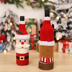 Knitted Christmas wine bottle covers with Santa and reindeer motifs for holiday table decor