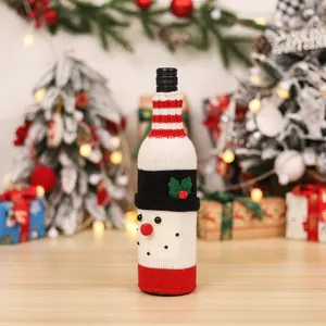 Knitted snowman wine bottle cover with red stripes for Christmas table decor