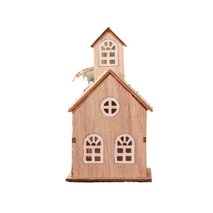Luminous miniature wooden Christmas house with snow-dusted roof and laser-cut windows