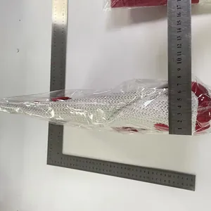Detailed measurement of red and white Santa hat chair cover using a steel ruler