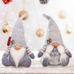 Set of two festive Christmas gnomes with grey knitted hats on a wooden table setup