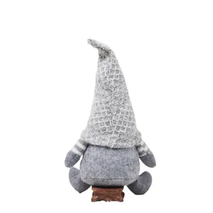 Nordic Christmas gnome plush with grey textured hat on a miniature wooden base
