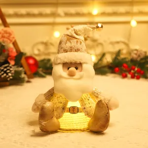 Lighted Santa Claus plush ornament with warm LED glow and festive sequin details