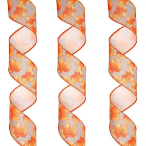 Close-up of harvest linen ribbon with realistic orange and yellow maple leaf patterns