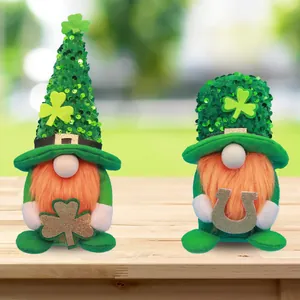 Two St. Patrick's Day gnomes with sequin hats and lucky shamrock on wooden table