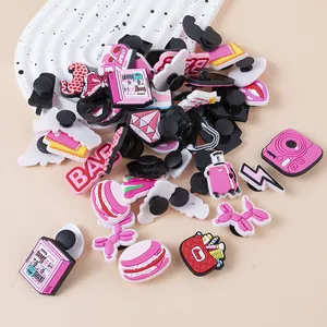 Pink PVC shoe charms set featuring camera and luggage designs for garden clogs decoration