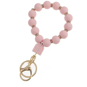 Detailed macro view of pink silicone beads with gold rhinestone spacers and a sturdy clasp
