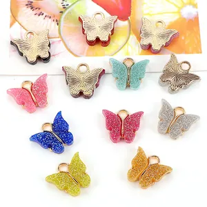 Ciondoli colorati a farfalla in resina con glitter e ganci dorati per creazione gioielli