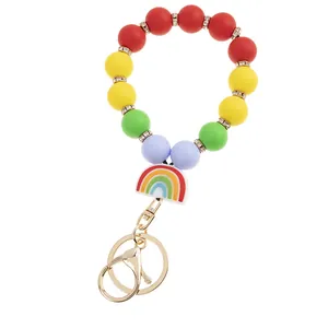 Detail of rainbow silicone beaded keychain with golden lobster clasp and charm