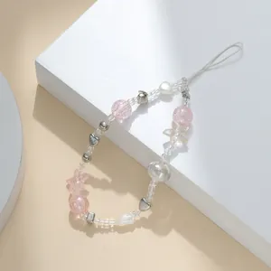 Detailed shot of pink tulip beaded phone charm with acrylic stars and metallic hearts