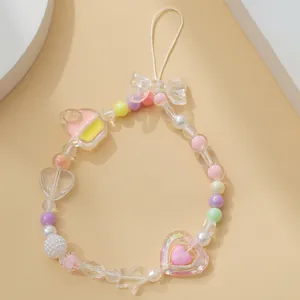 Dettaglio di un cordino per cellulare in perline stile Y2K con cupcake e ciondoli a cuore