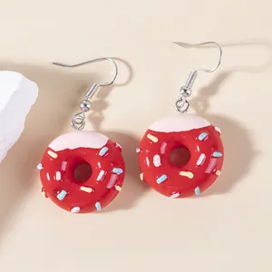 Sweet red donut earrings with pink frosting and colorful sprinkles for a cute look