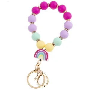 Detail of colorful silicone beaded keychain with rainbow charm and gold metal hook