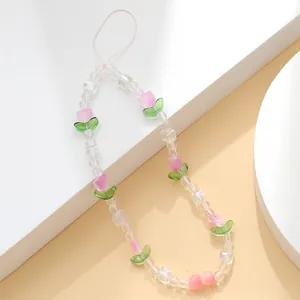 Detail of beaded phone strap featuring pink tulips and clear acrylic faceted beads