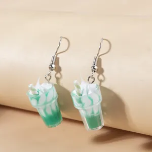 Creative mint milkshake sundae earrings with cream top and blue straw details
