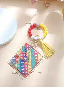 Detail of Christmas themed silicone bead keychain with striped PU card holder and tassel