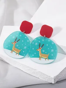Macro detail of Christmas acrylic drop earrings with reindeer and snowflake motifs