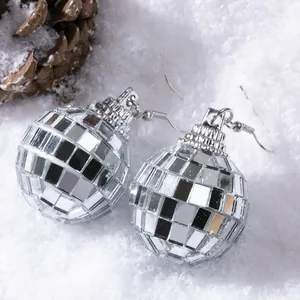 Vintage silver disco ball drop earrings for women with mirror tiles on festive snow background