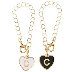 Gold chain heart pendants with black and white enamel letter C charms and lobster clasp