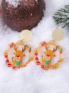 Detailed macro of acrylic Christmas earrings with reindeer design and festive elements